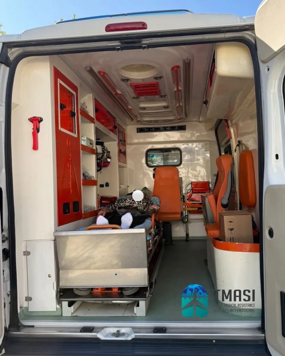A patient resting on a stretcher inside a TMASI-arranged ambulance