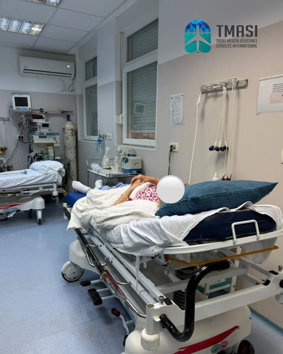 A patient resting on a hospital bed in the emergency ward